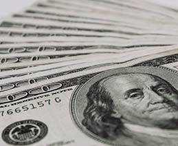 Closeup of several hundred dollar bills. As financial services increasingly move online, so does the need for accessible websites for bank and other financial institutions.